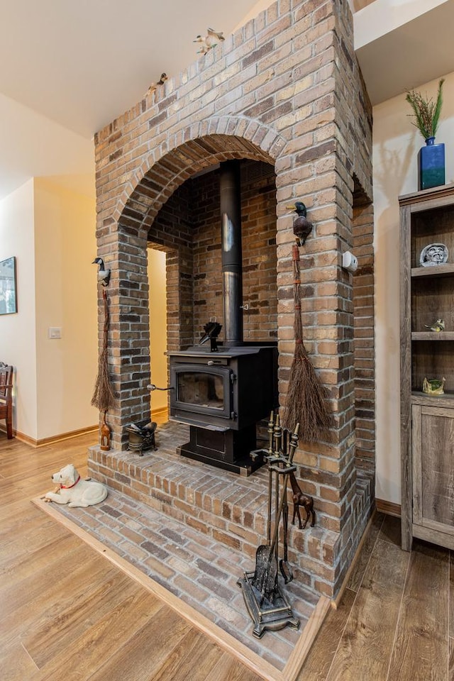 21 Carribean Dr, Putnam, IL 61560 - detailed view of wood finished floors, a wood stove, baseboards, and arched walkways