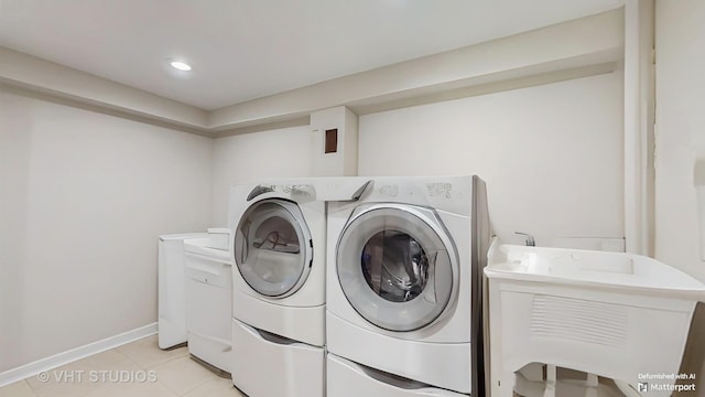5304 N Oriole Ave, Chicago, IL 60656 - laundry room featuring washer and clothes dryer, light tile patterned floors, and baseboards