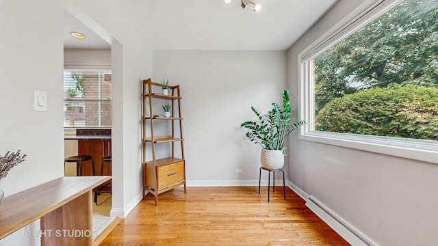 5304 N Oriole Ave, Chicago, IL 60656 - living area with light wood-type flooring, healthy amount of natural light, baseboard heating, and baseboards