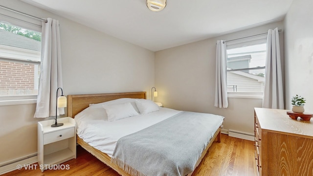 5304 N Oriole Ave, Chicago, IL 60656 - bedroom featuring baseboard heating, a baseboard radiator, light wood-type flooring, and baseboards