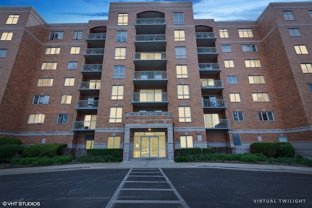 6807 N Milwaukee Ave Unit 204, Niles, IL 60714 - view of apartment building / complex featuring uncovered parking