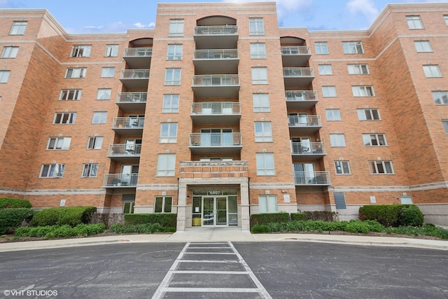 6807 N Milwaukee Ave Unit 204, Niles, IL 60714 - view of apartment building / complex featuring uncovered parking
