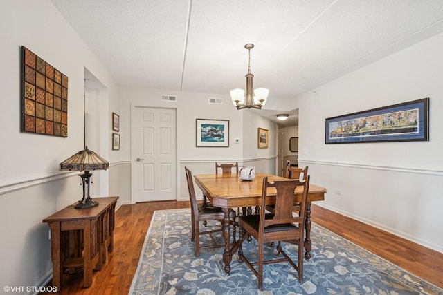 6807 N Milwaukee Ave Unit 204, Niles, IL 60714 - dining room with wood finished floors, a chandelier, and baseboards