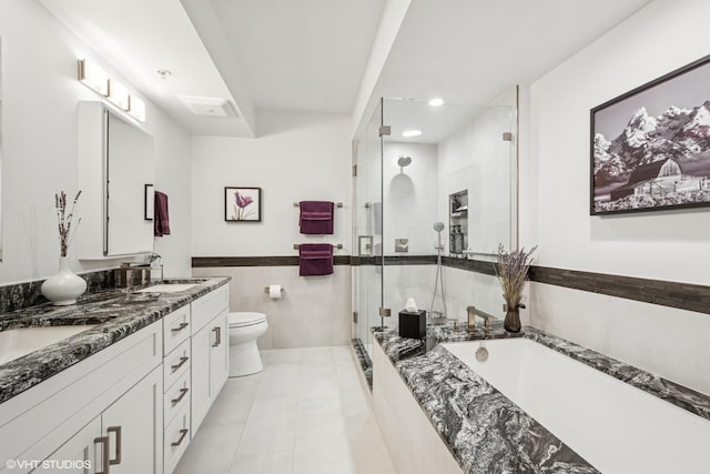6807 N Milwaukee Ave Unit 204, Niles, IL 60714 - bathroom featuring a stall shower, toilet, a garden tub, tile walls, and double vanity