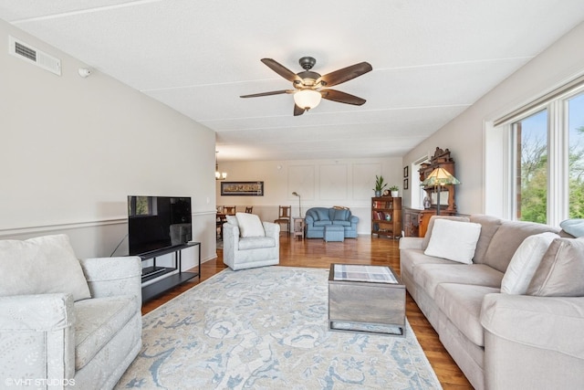 6807 N Milwaukee Ave Unit 204, Niles, IL 60714 - living area featuring a ceiling fan, wood finished floors, and a chandelier