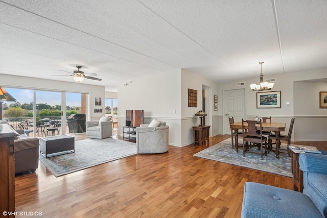 6807 N Milwaukee Ave Unit 204, Niles, IL 60714 - living area with a chandelier, a textured ceiling, light wood finished floors, and ceiling fan