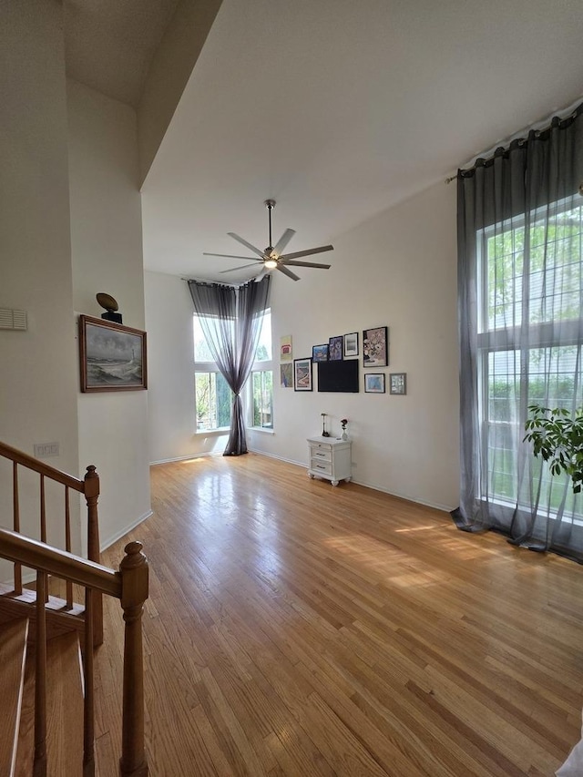 7943 Dada Dr, Gurnee, IL 60031 - unfurnished living room featuring ceiling fan, light wood-style floors, and baseboards