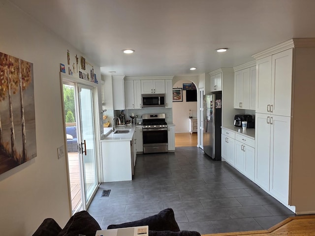 7943 Dada Dr, Gurnee, IL 60031 - kitchen with stainless steel appliances, a sink, light countertops, white cabinetry, and recessed lighting