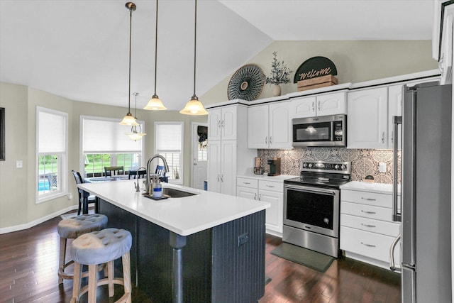 1228 N County Road 530 Rd E, Tuscola, IL 61953 - kitchen with stainless steel appliances, vaulted ceiling, dark wood finished floors, white cabinets, and backsplash