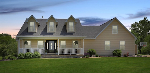 1228 N County Road 530 Rd E, Tuscola, IL 61953 - cape cod-style house with a yard, a porch, and roof with shingles