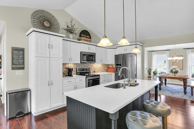 1228 N County Road 530 Rd E, Tuscola, IL 61953 - kitchen with stainless steel appliances, dark wood-type flooring, a breakfast bar, white cabinetry, and high vaulted ceiling