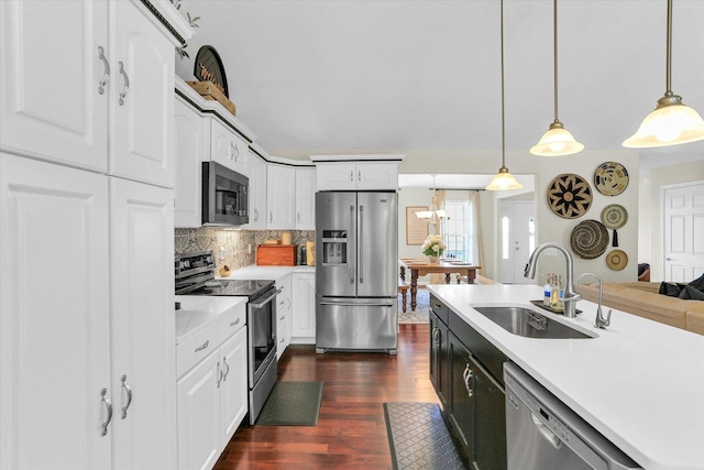 1228 N County Road 530 Rd E, Tuscola, IL 61953 - kitchen featuring appliances with stainless steel finishes, dark wood-style flooring, decorative backsplash, and white cabinetry