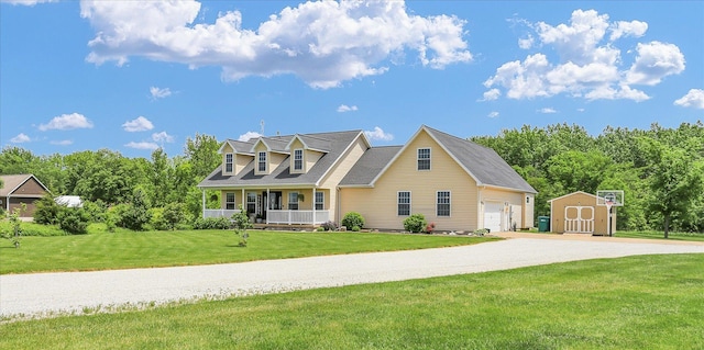 1228 N County Road 530 Rd E, Tuscola, IL 61953 - cape cod house featuring a shed, a porch, a garage, a front lawn, and driveway