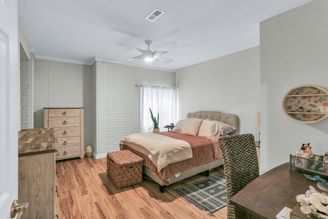 1228 N County Road 530 Rd E, Tuscola, IL 61953 - bedroom with light wood finished floors, ceiling fan, and brick wall