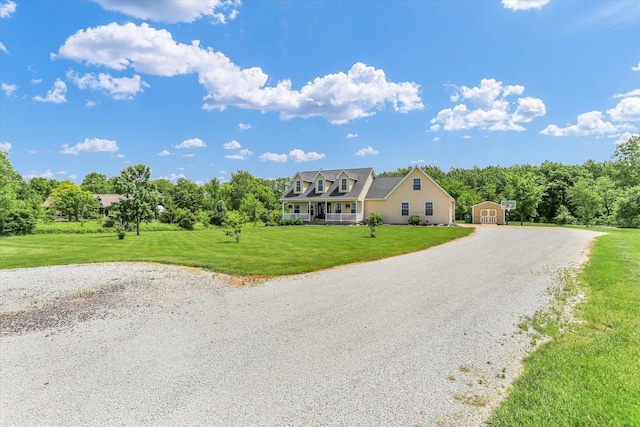 1228 N County Road 530 Rd E, Tuscola, IL 61953 - cape cod house featuring a storage unit, a front yard, and driveway