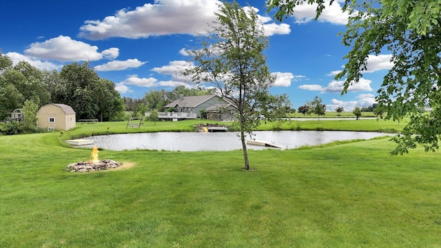 1228 N County Road 530 Rd E, Tuscola, IL 61953 - view of grassy yard with a water view and a storage unit
