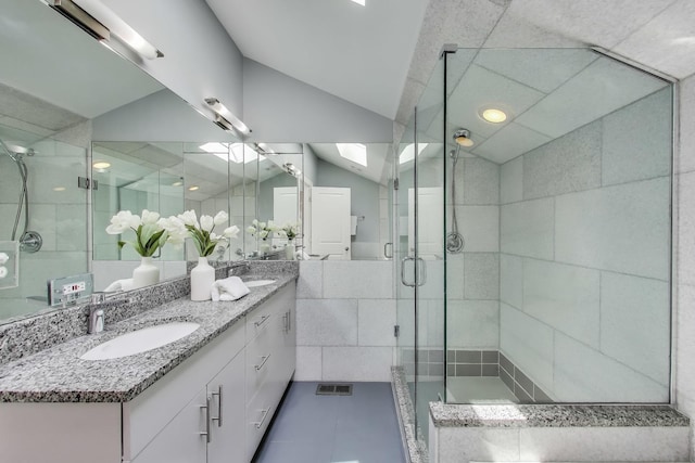 847 N Damen Ave Unit 2R, Chicago, IL 60622 - full bathroom with double vanity, a stall shower, lofted ceiling, a skylight, and tile patterned floors