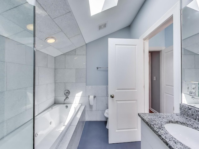 847 N Damen Ave Unit 2R, Chicago, IL 60622 - full bathroom featuring tile walls, a tub with jets, vanity, tile patterned flooring, and recessed lighting