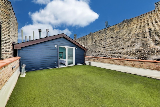 847 N Damen Ave Unit 2R, Chicago, IL 60622 - back of property featuring brick siding and a lawn