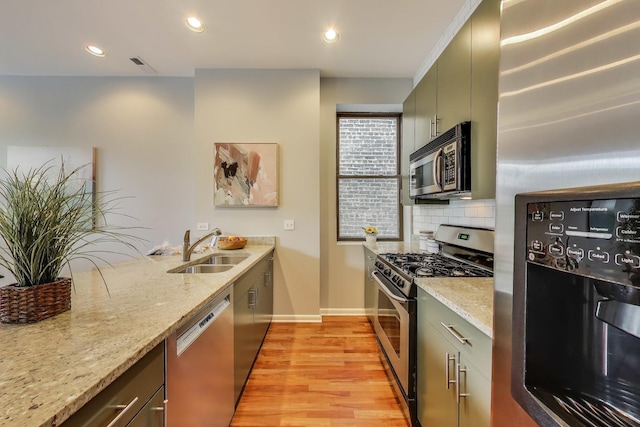 847 N Damen Ave Unit 2R, Chicago, IL 60622 - kitchen with appliances with stainless steel finishes, decorative backsplash, light wood-type flooring, light stone countertops, and recessed lighting