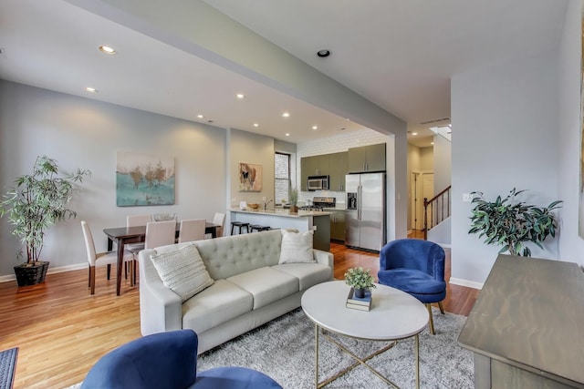 847 N Damen Ave Unit 2R, Chicago, IL 60622 - living room featuring light wood-style flooring, recessed lighting, and stairway