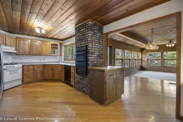 kitchen featuring wooden ceiling, black appliances, light wood-type flooring, a sink, and glass insert cabinets