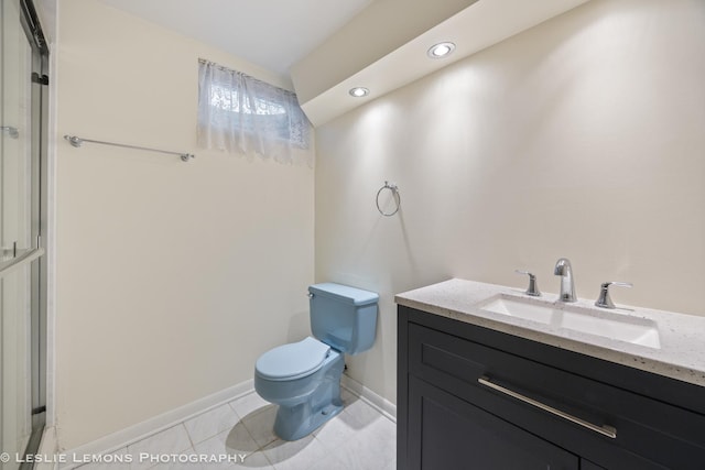 bathroom featuring toilet, vanity, recessed lighting, baseboards, and a shower with door