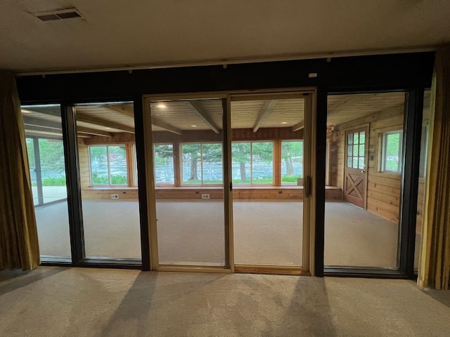 doorway to outside with carpet floors
