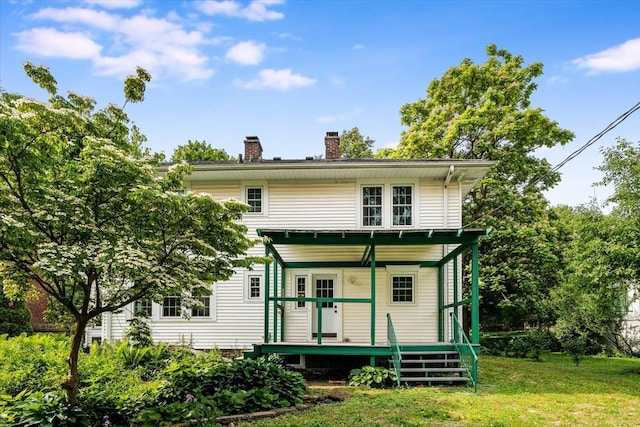 408 W Iowa St, Urbana, IL 61801 - rear view of house with a chimney, a lawn, and a deck