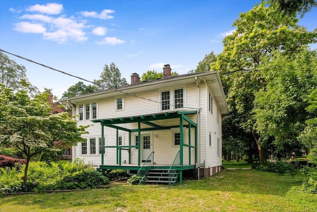 408 W Iowa St, Urbana, IL 61801 - back of house with a chimney, a lawn, and a wooden deck