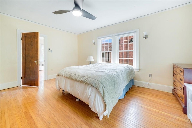 408 W Iowa St, Urbana, IL 61801 - bedroom with light wood-style flooring, baseboards, and a ceiling fan