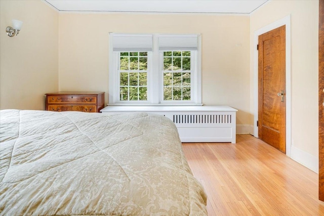 408 W Iowa St, Urbana, IL 61801 - bedroom with wood finished floors, baseboards, and crown molding