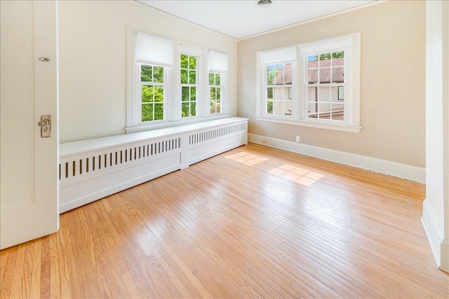 408 W Iowa St, Urbana, IL 61801 - spare room with healthy amount of natural light, hardwood / wood-style floors, baseboards, and crown molding