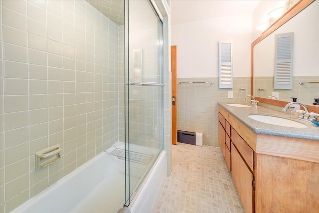 408 W Iowa St, Urbana, IL 61801 - bathroom featuring combined bath / shower with glass door, tile walls, double vanity, a baseboard heating unit, and wainscoting
