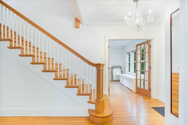 408 W Iowa St, Urbana, IL 61801 - stairway featuring wood finished floors, ornamental molding, a chandelier, and baseboards