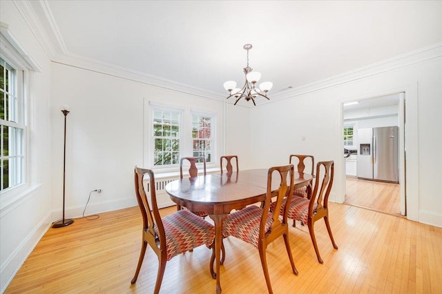 408 W Iowa St, Urbana, IL 61801 - dining space featuring light wood-style floors, a chandelier, crown molding, and baseboards