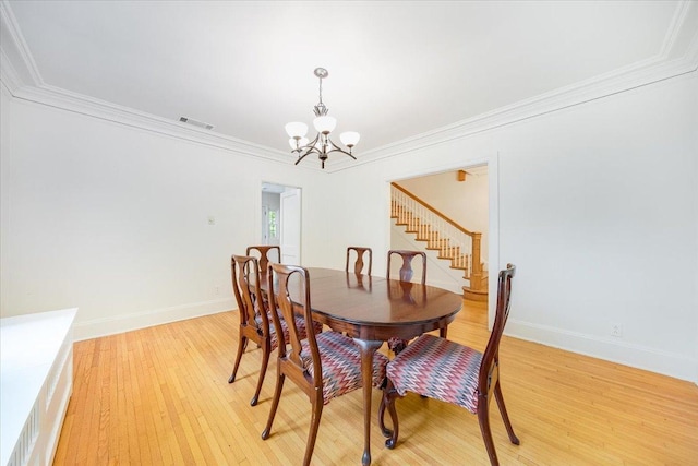 408 W Iowa St, Urbana, IL 61801 - dining area with a chandelier, stairs, light wood-style flooring, ornamental molding, and baseboards
