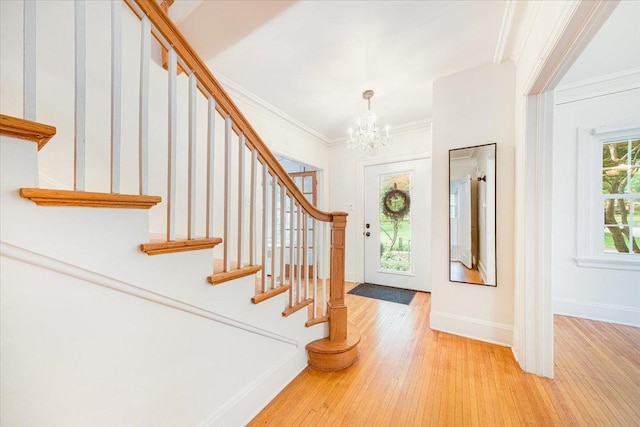 408 W Iowa St, Urbana, IL 61801 - entryway with stairway, a chandelier, light wood-type flooring, crown molding, and baseboards