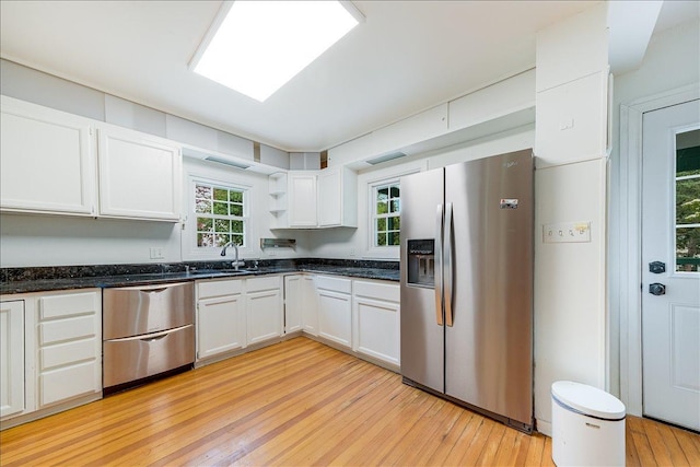 408 W Iowa St, Urbana, IL 61801 - kitchen featuring stainless steel appliances, a sink, light wood-type flooring, open shelves, and white cabinets