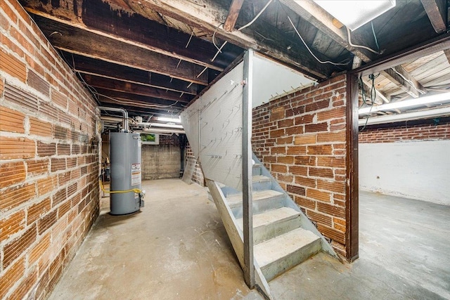 408 W Iowa St, Urbana, IL 61801 - unfinished basement featuring gas water heater, stairway, and brick wall
