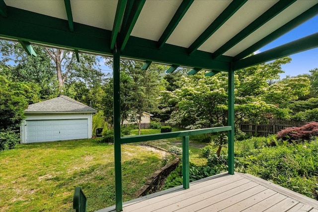 408 W Iowa St, Urbana, IL 61801 - deck featuring a detached garage, an outbuilding, and view of wooded area