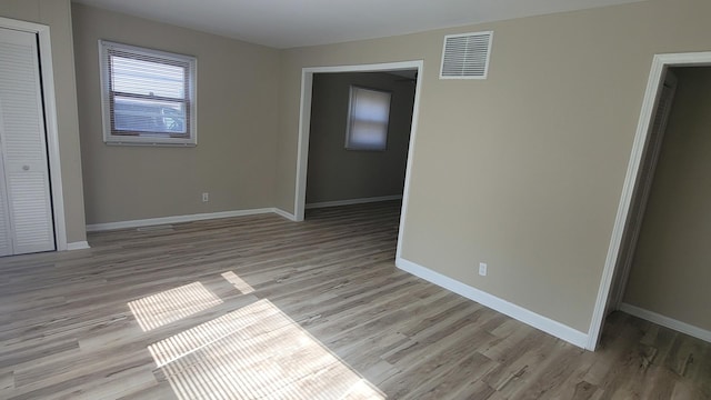 107 Georgine St, Crystal Lake, IL 60014 - unfurnished bedroom featuring light wood-style floors, baseboards, and a closet