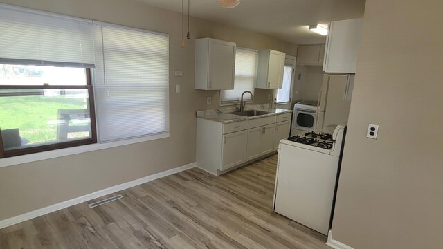 107 Georgine St, Crystal Lake, IL 60014 - kitchen featuring white appliances, a sink, baseboards, light countertops, and white cabinetry