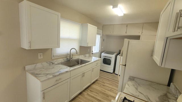107 Georgine St, Crystal Lake, IL 60014 - kitchen featuring washer / clothes dryer, a sink, light wood finished floors, white cabinetry, and freestanding refrigerator