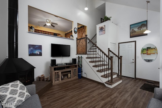 543 White Birch Rd, Lindenhurst, IL 60046 - living room featuring wood finished floors, a towering ceiling, ceiling fan, stairs, and baseboards