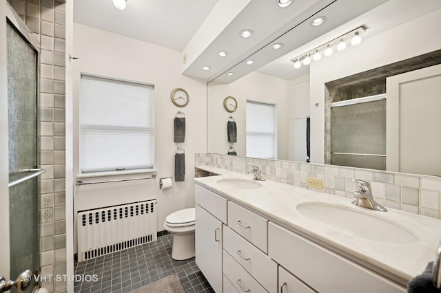 1431 Noyes St, Evanston, IL 60201 - bathroom with radiator, toilet, tile patterned floors, double vanity, and a tile shower