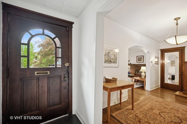 1431 Noyes St, Evanston, IL 60201 - entryway with dark wood finished floors, arched walkways, and baseboards