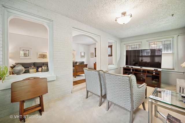 1431 Noyes St, Evanston, IL 60201 - carpeted dining room featuring arched walkways and a textured ceiling