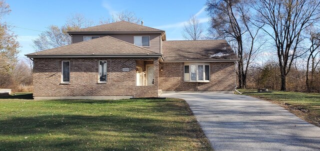 22503 S State St, Steger, IL 60475 - view of front facade featuring brick siding, driveway, a front yard, and a shingled roof