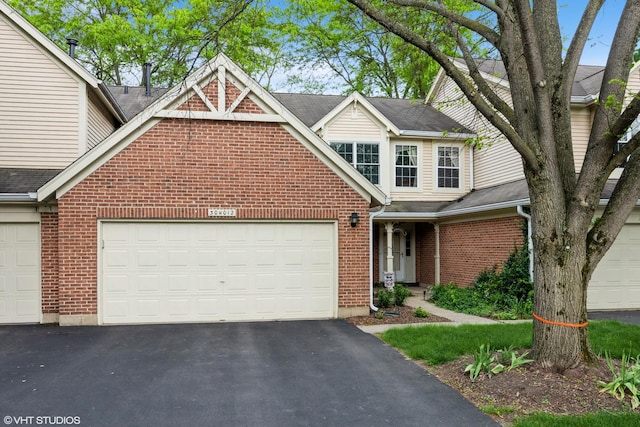 30W012 Laurel Ct, Warrenville, IL 60555 - traditional home with asphalt driveway, an attached garage, brick siding, and roof with shingles